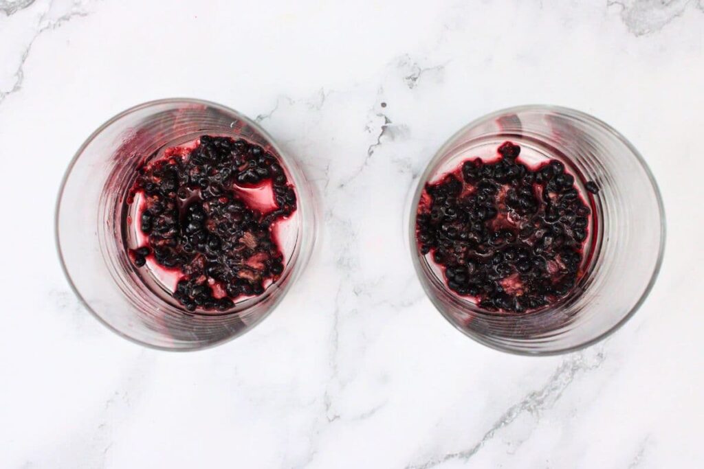 add fresh blackberries to a lowball glass and muddle them