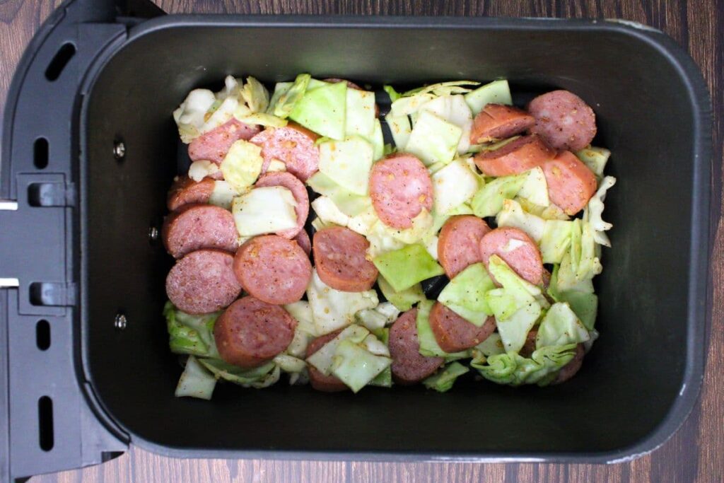 add sausage and cabbage mixture to air fryer basket