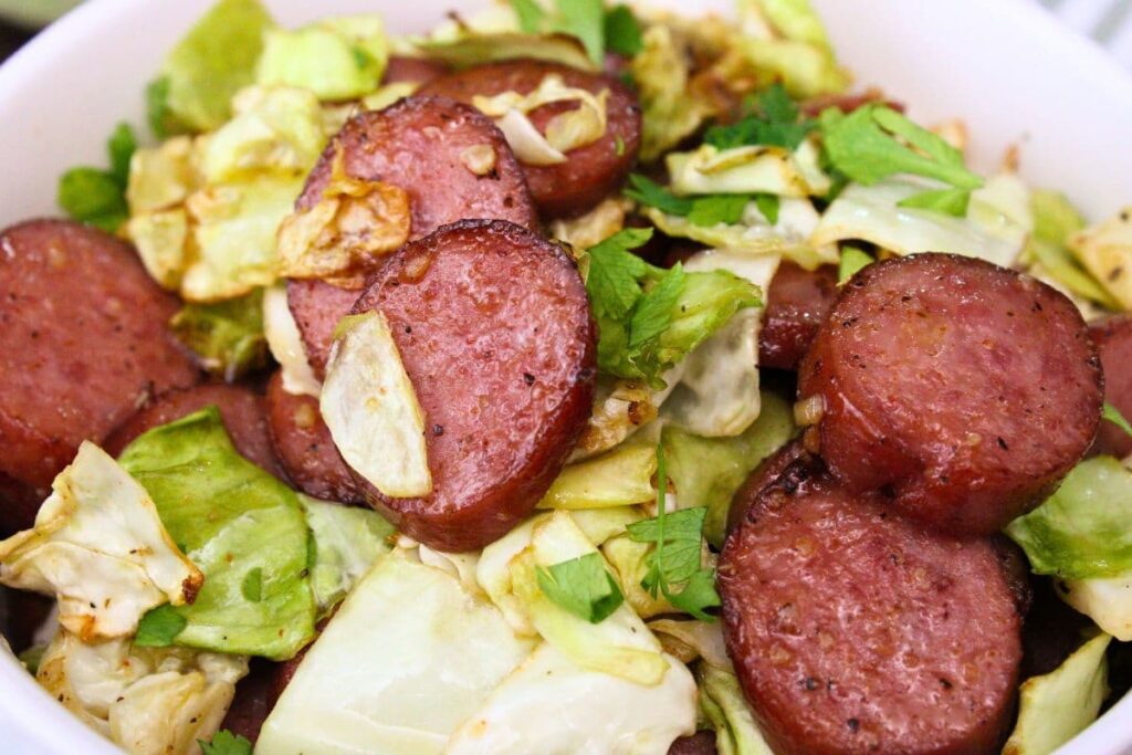 closeup view of air fryer cabbage and sausage in a bowl