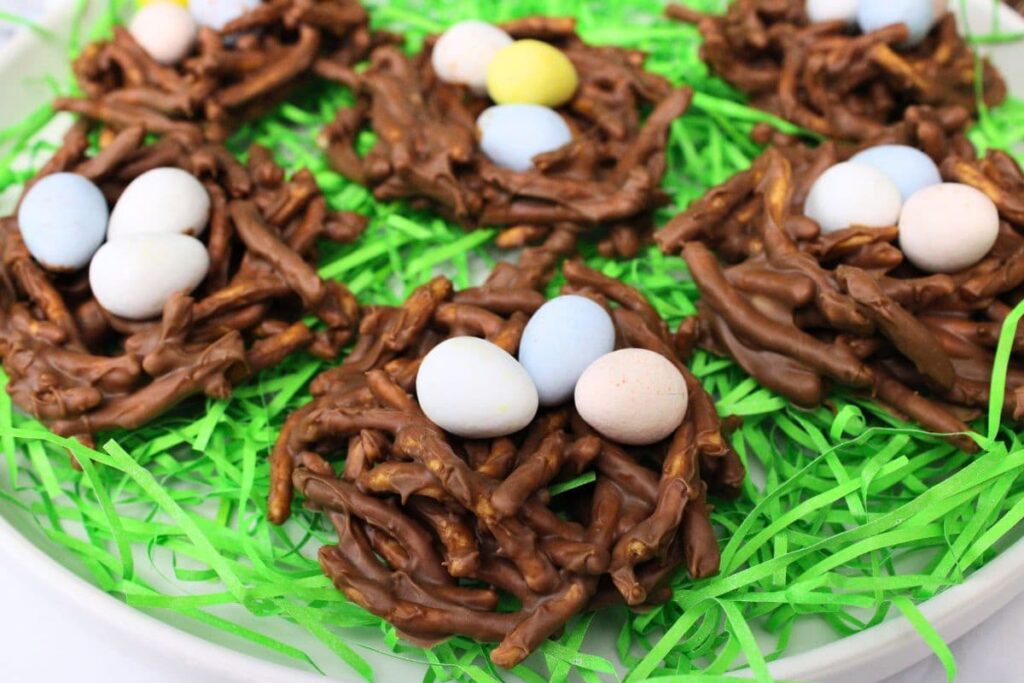closeup view of chocolate butterscotch birds nest treats on a bed of fake Easter grass