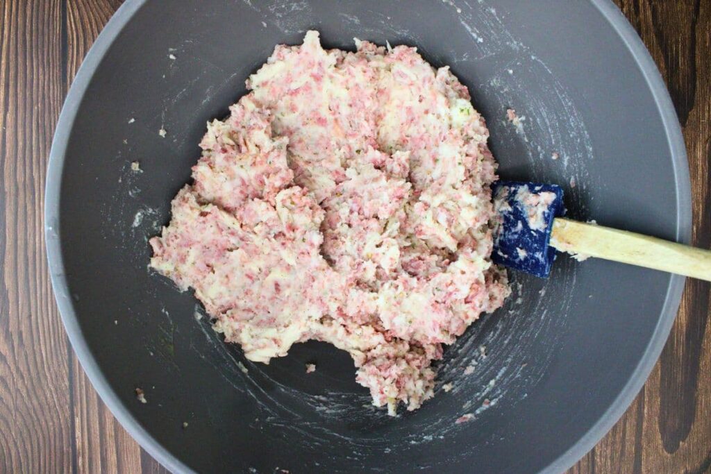 combine cold mashed potatoes, sauerkraut, swiss cheese, corned beef, egg, and seasonings in a mixing bowl