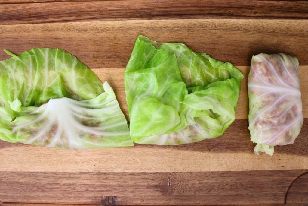 fold the cabbage leaf over the filling to form the roll