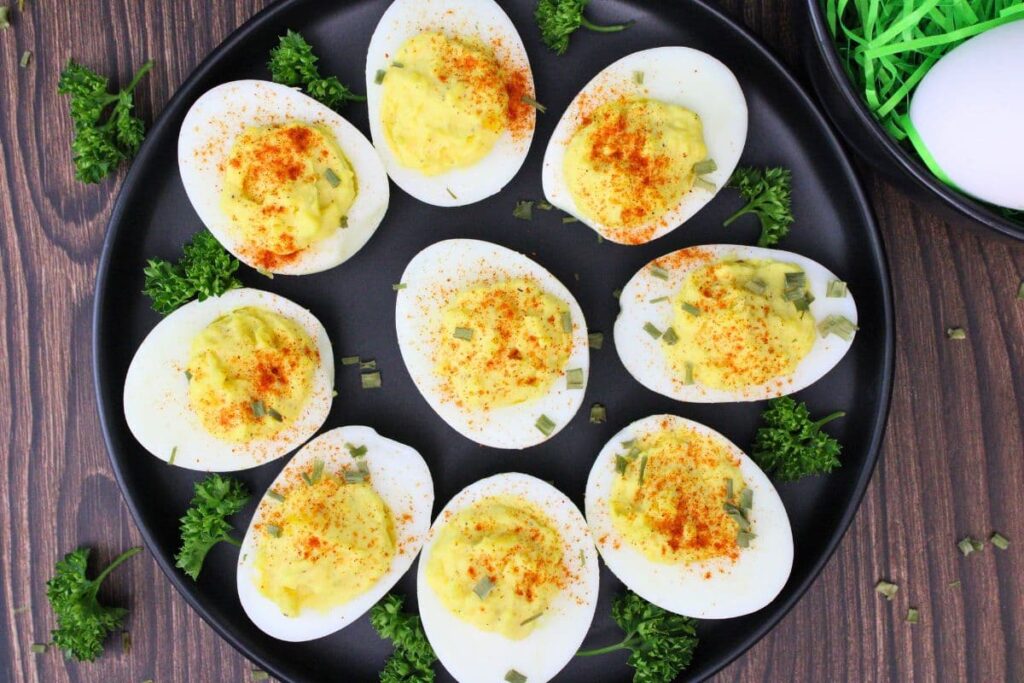 overhead view of air fryer deviled eggs circling a black plate