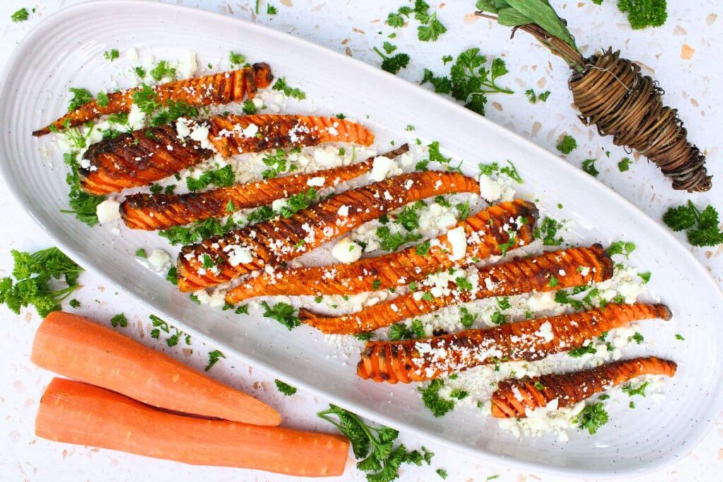 overhead view of air fryer hasselback carrots on a serving platter