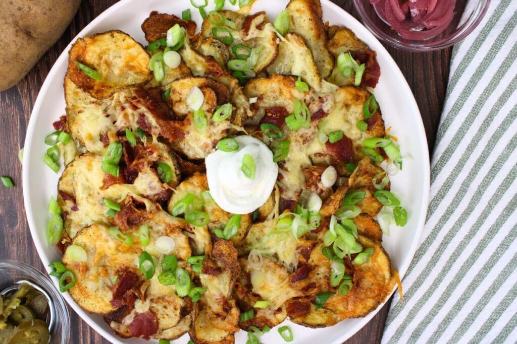 overhead view of air fryer irish nachos on a plate with sour cream