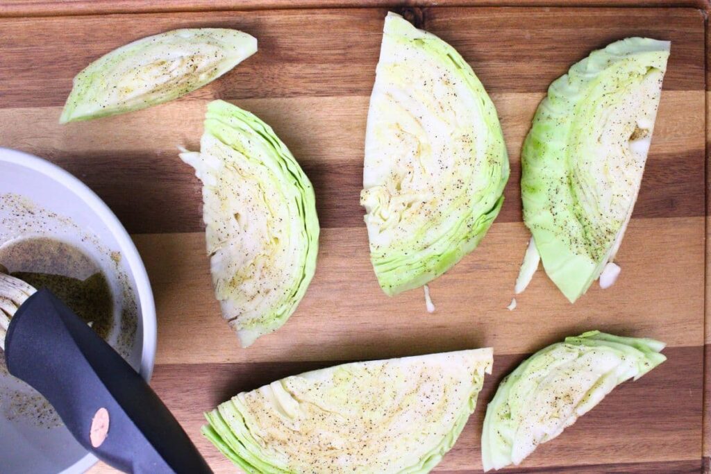 season cabbage wedges with olive oil, salt, pepper, and garlic powder