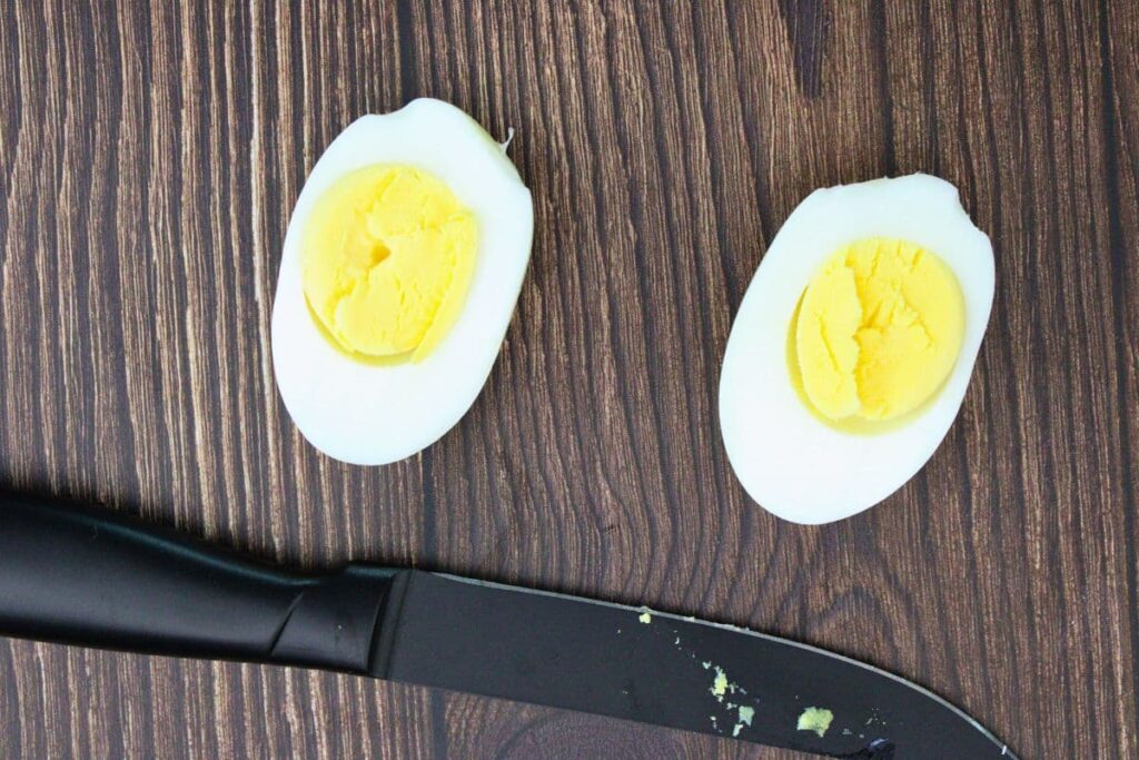 slice hard boiled egg lengthwise with a knife