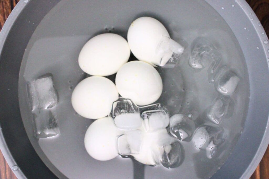 transfer cooked eggs to ice water bath to cool