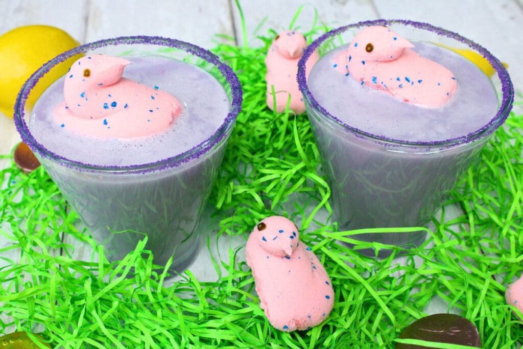 two peeps martini cocktails with marshmallow chicks and fake grass