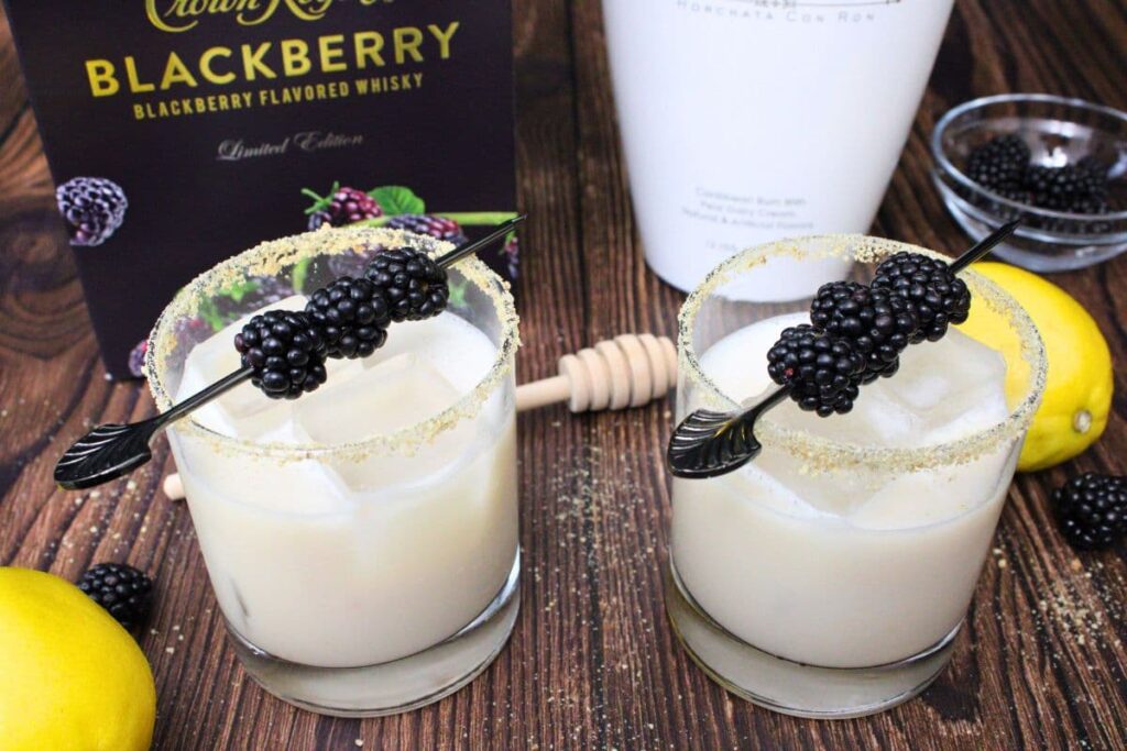 two whiskey glasses filled with blackberry cobbler cocktails