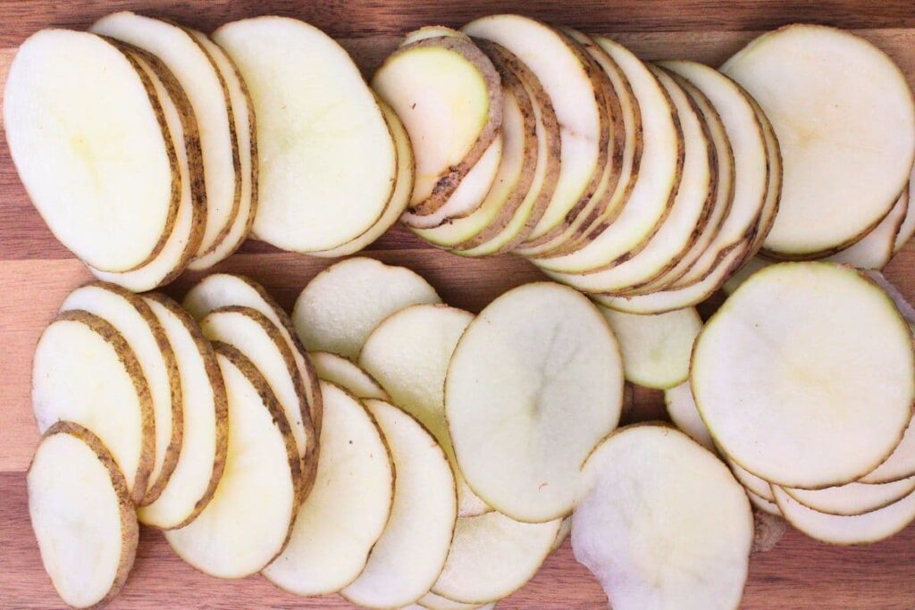wash, dry, and cut potatoes into thin slices