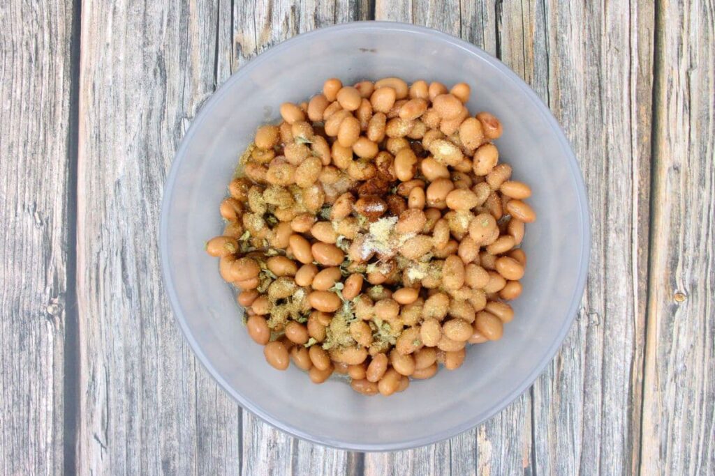 add beans, chicken broth, and seasonings to a microwave safe bowl