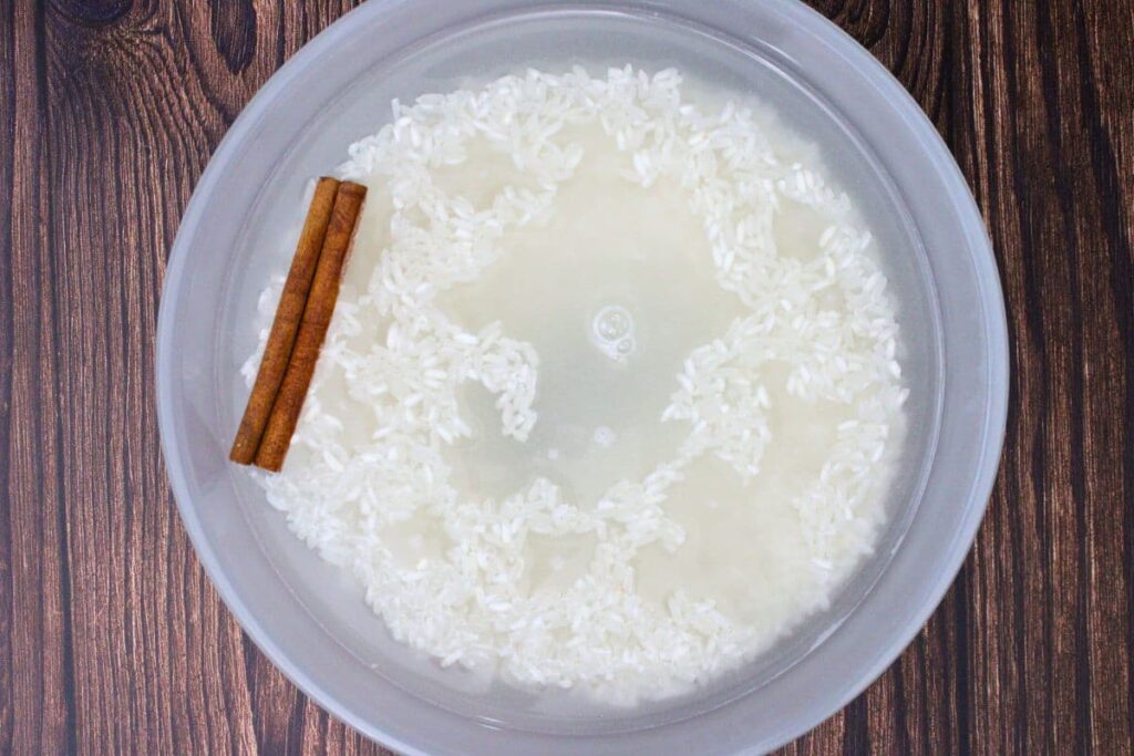 add rice, water, salt, and cinnamon stick to large microwave safe bowl