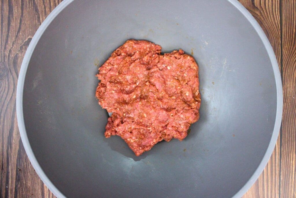 combine ground beef and taco seasoning in a mixing bowl