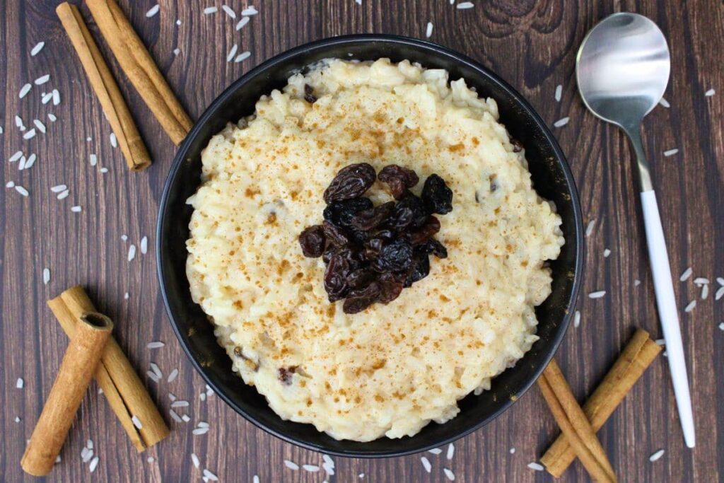 overhead view of rice pudding topped with raisins in a bowl