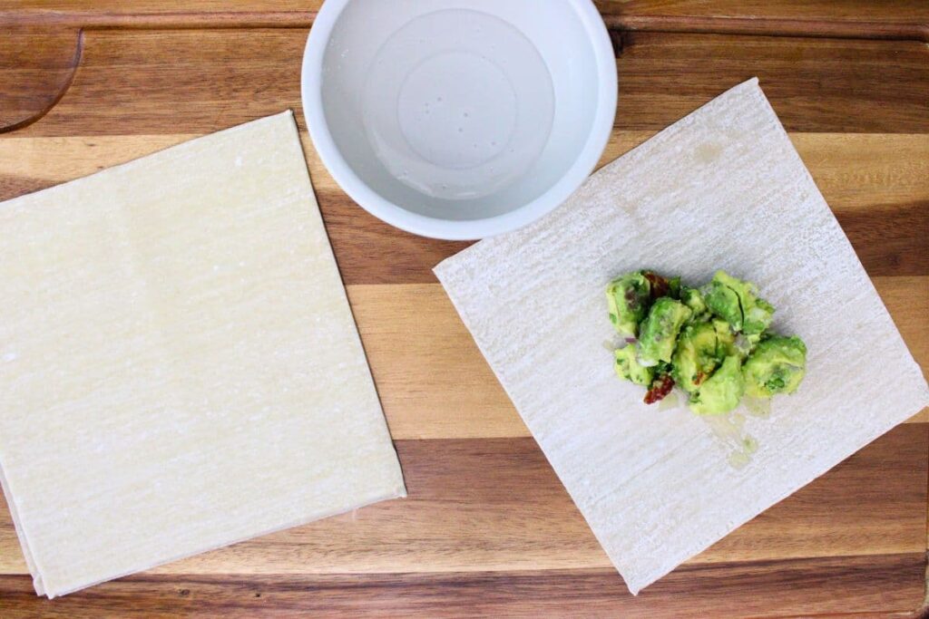 place avocado filling in the center of egg roll wrapper