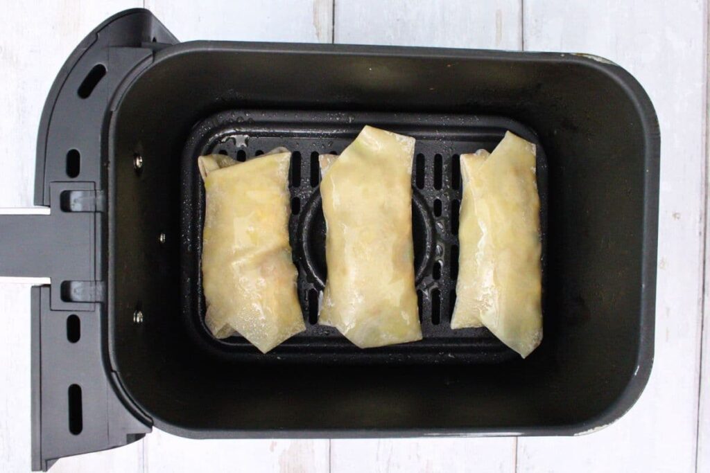 place taco egg rolls in air fryer basket
