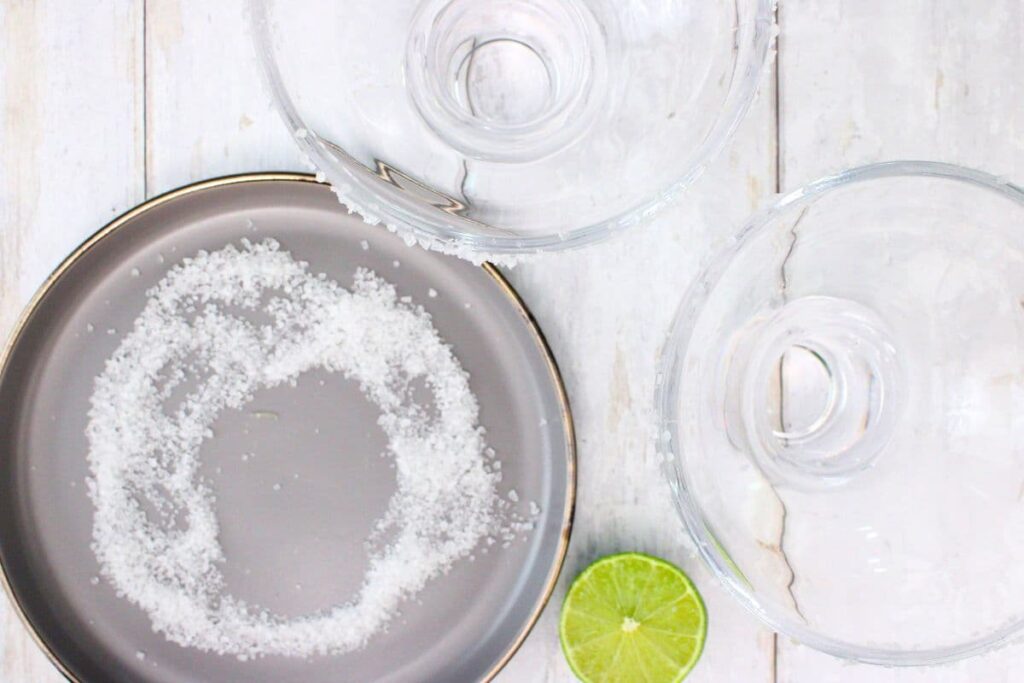 rub a lime around the glass rim then dip in salt