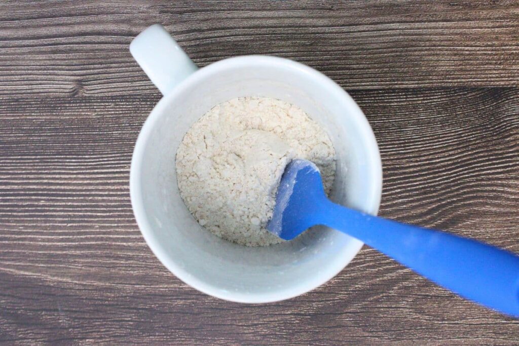 add dry ingredients - flour, sugar, baking powder, and salt to a microwave safe mug
