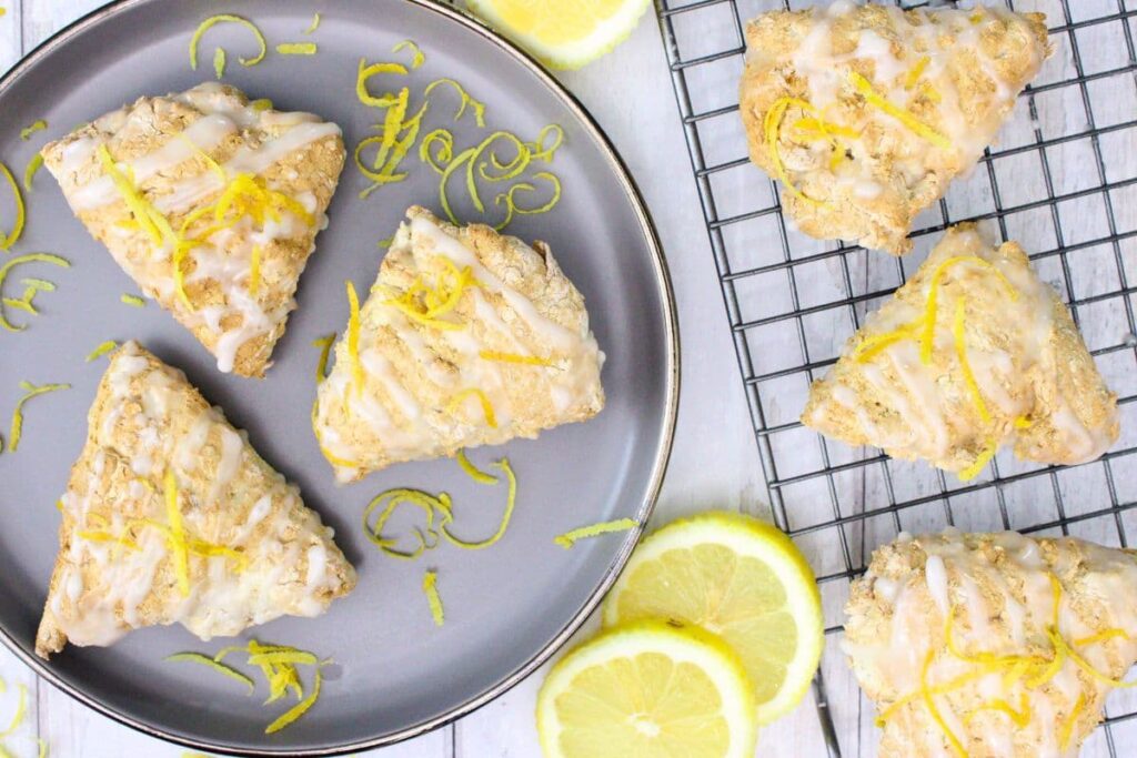 overhead view of glazed air fryer lemonade scones on a plate and wire rack