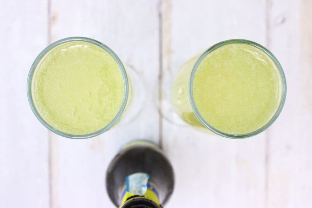 slowly pour champagne or prosecco over limoncello and gin