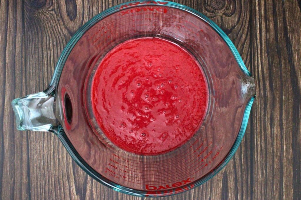 blend raspberries, lemon juice, water, and honey then strain to remove seeds
