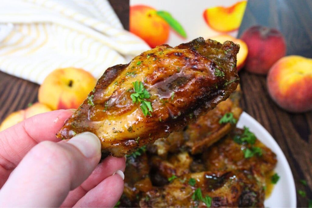 holding up an air fryer crown royal peach wing
