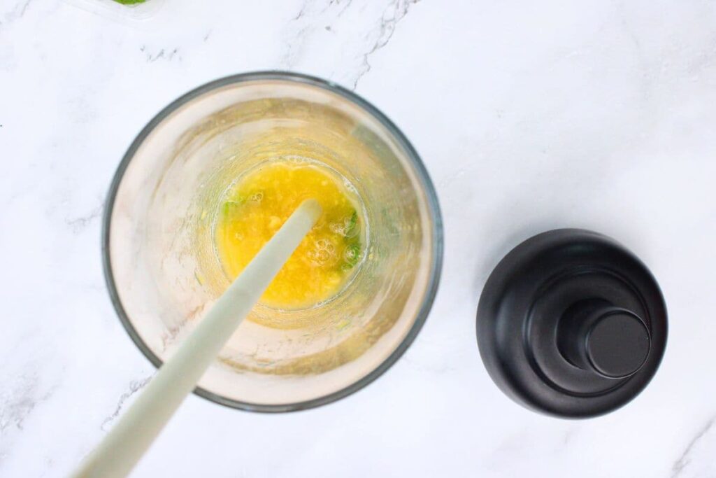 muddle the mint and peaches with a wooden spoon