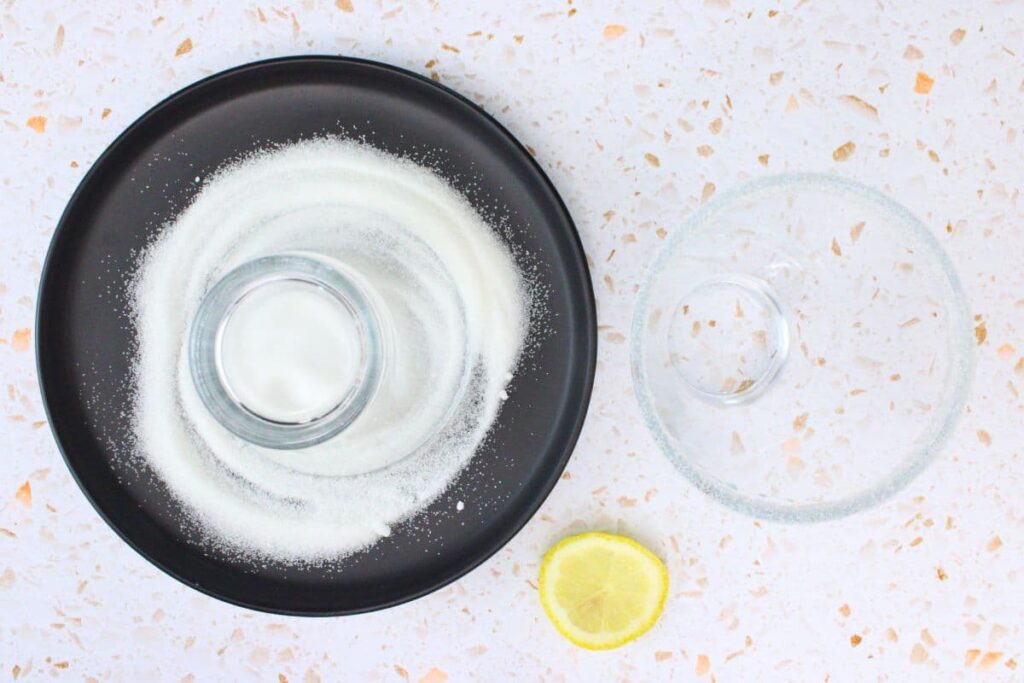 run a lemon wedge around the glass and dip the rim in sugar