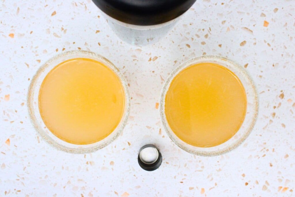 shake and strain peach lemon drop into rimmed glass