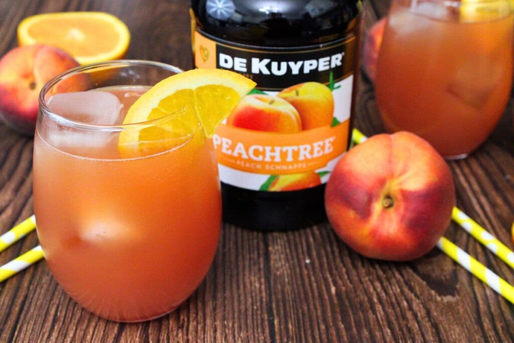 texas roadhouse peach fuzz cocktail next to peach schnapps bottle