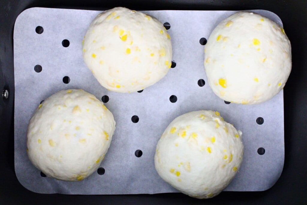 place filled peach biscuit bombs in air fryer basket