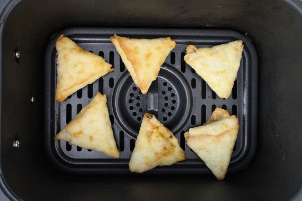 place frozen trader joes samosas in air fryer basket