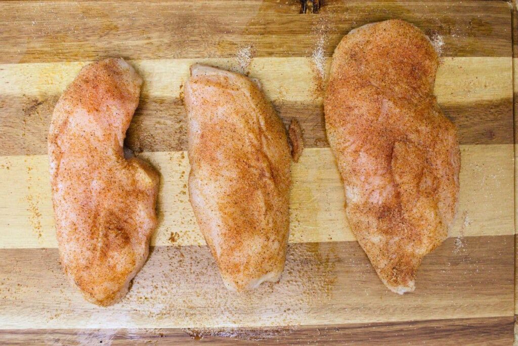 rub chicken with olive oil and sprinkle seasoning blend over top
