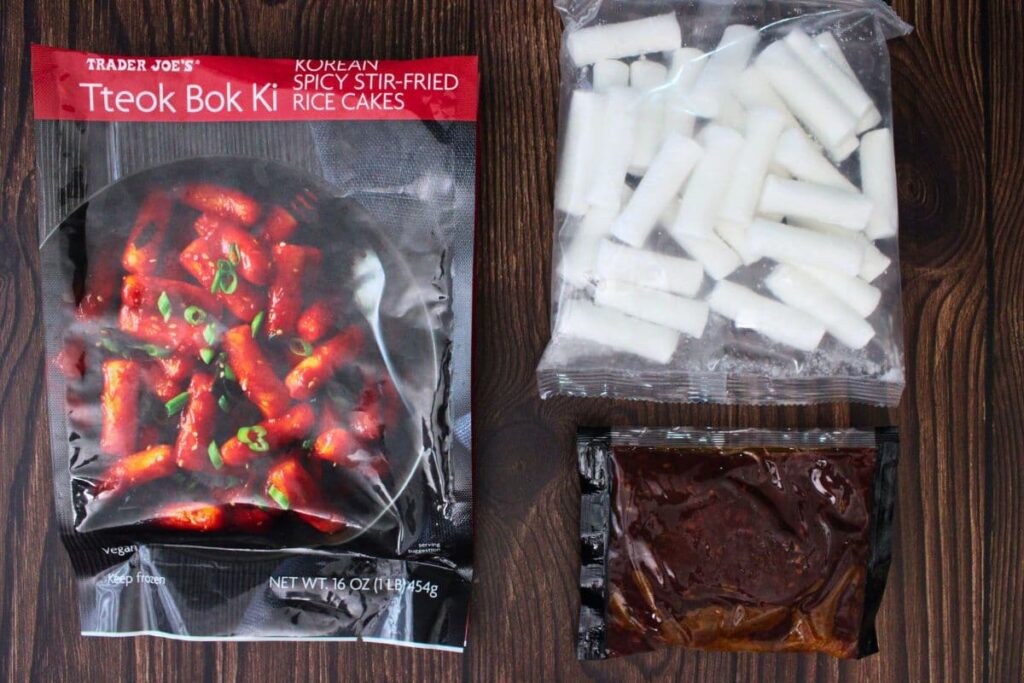 trader joes tteokbokki frozen rice cakes and sauce next to the bag