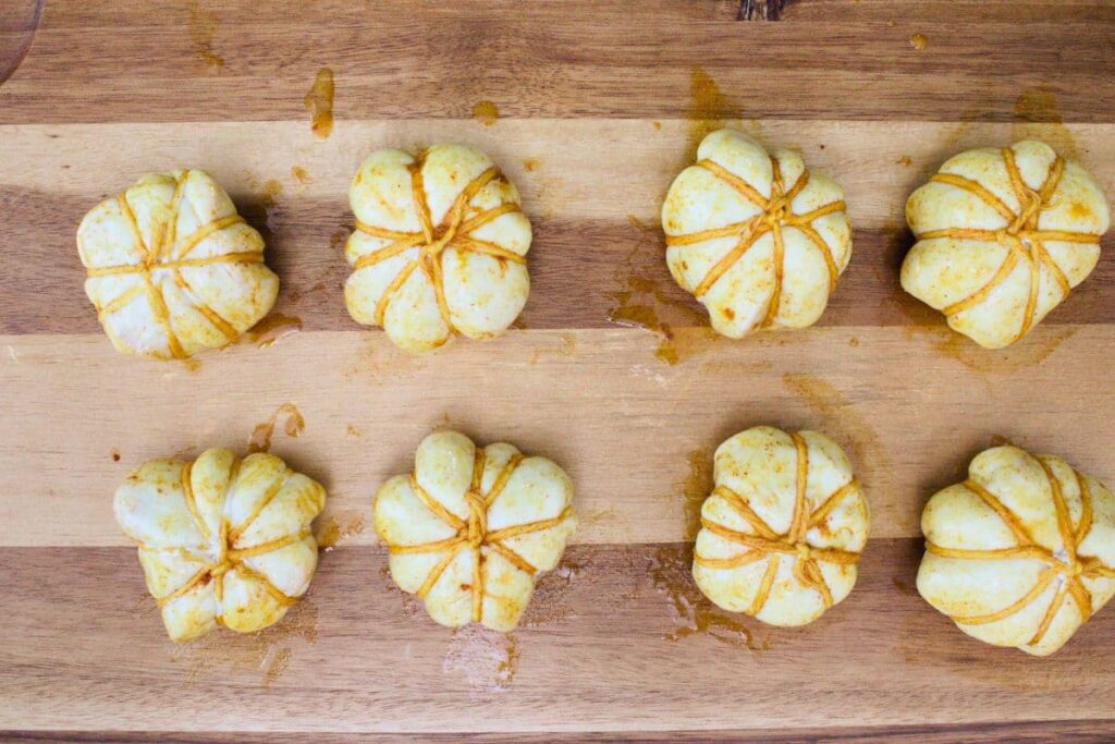 brush wrapped dough balls with seasoned egg wash
