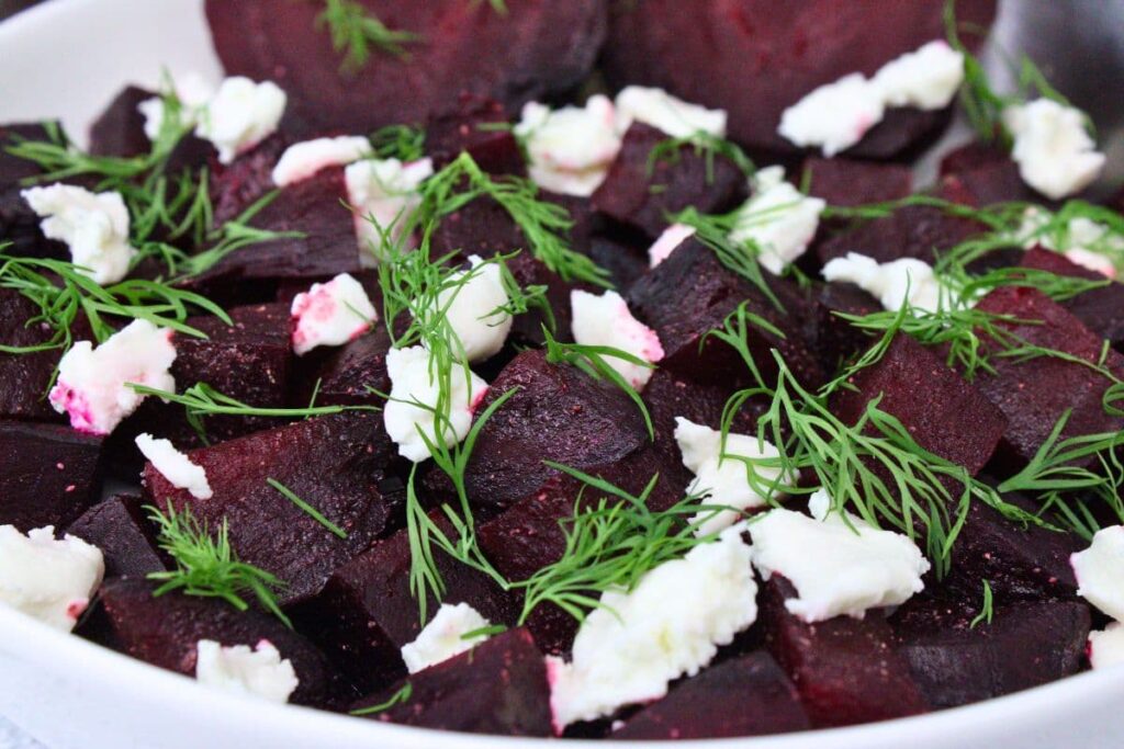 closeup view of microwave beets with goat cheese and dill