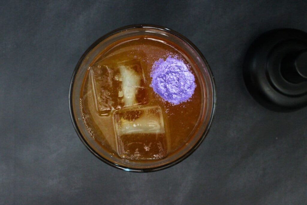 combine apple vodka, blackberry brandy, apple cider, lemon juice, grenadine, and luster dust in cocktail shaker