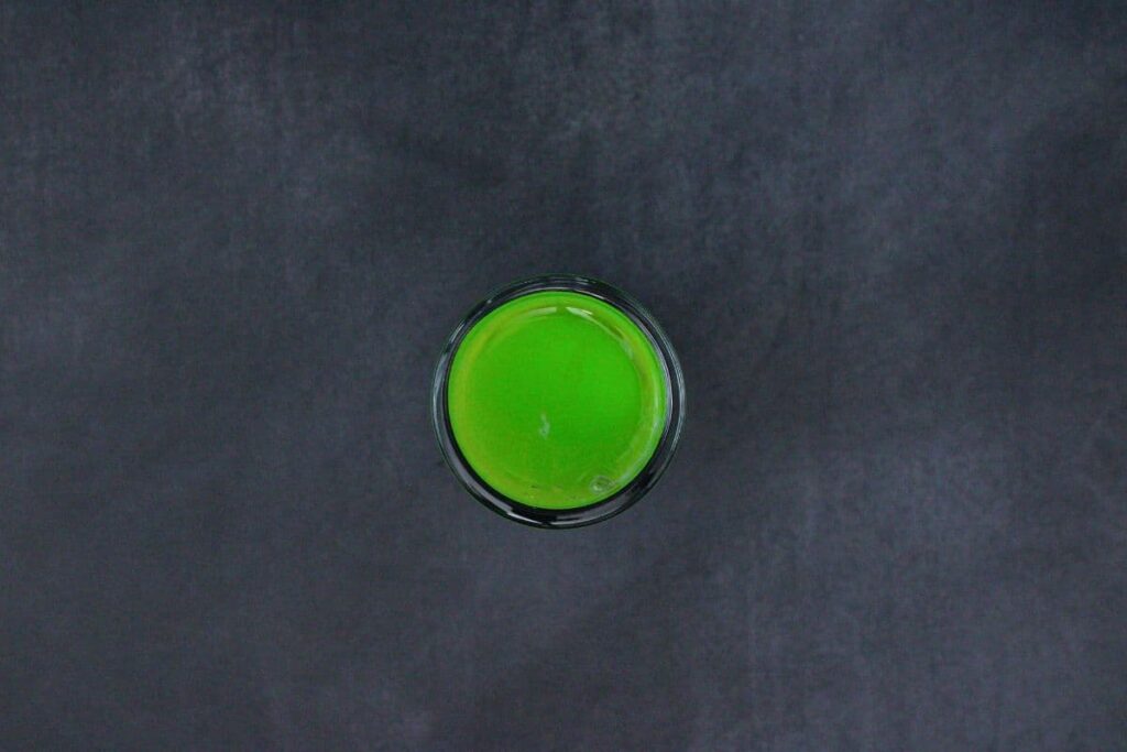 finally add a top layer of midori melon liqueur