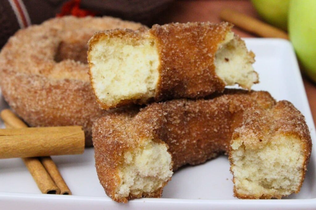 half air fryer apple cider donut stacked on top of each other on a plate