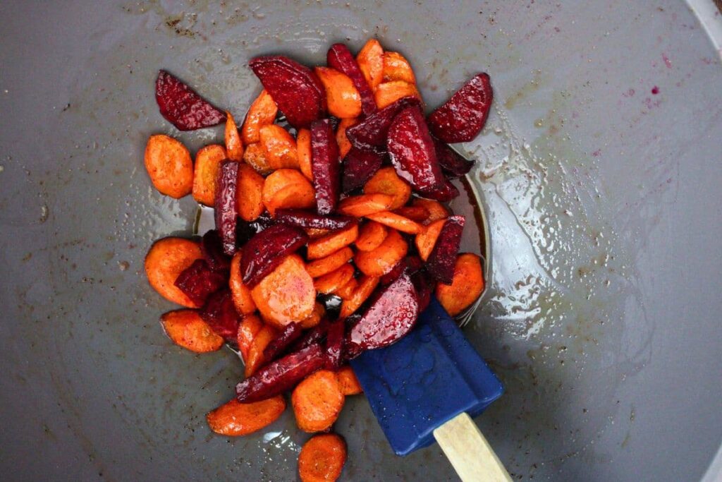 once beets and carrots are soft coat them with honey and butter in a mixing bowl