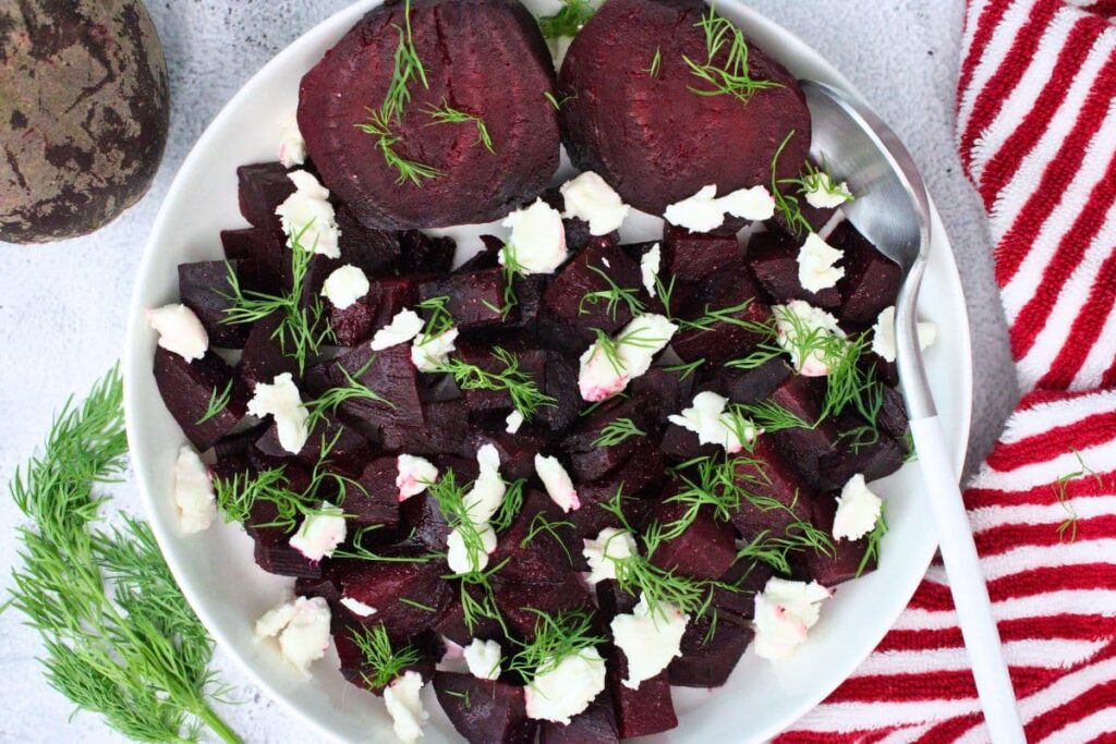 overhead view of diced and sliced microwave beets with goat cheese and dill
