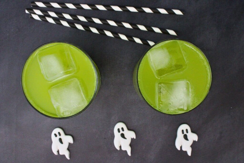overhead view of two ghostbusters cocktails with candy ghosts and striped straws