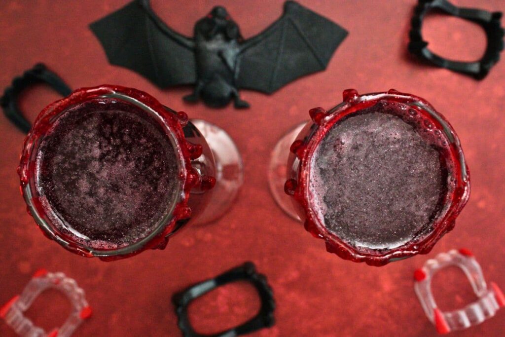 overhead view of two vampire mimosas surrounded by fake plastic fangs