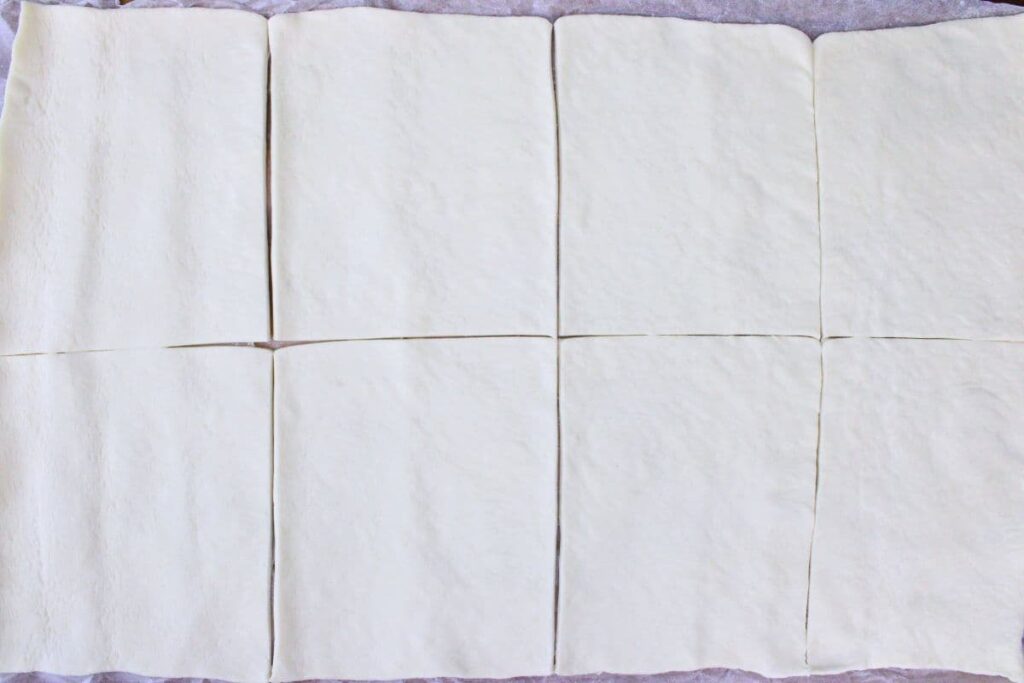 roll out pizza dough and cut into even pieces