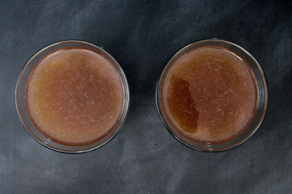 shake and strain witch's heart cocktail into martini glasses