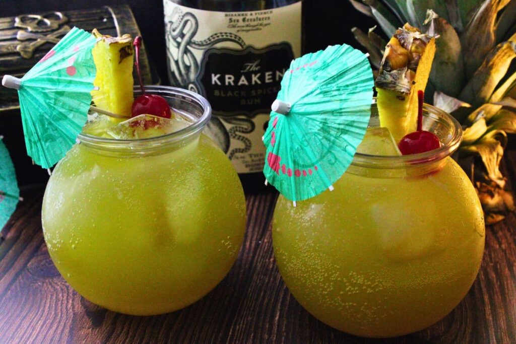 two drunken pirate drinks side by side with blue cocktail umbrellas