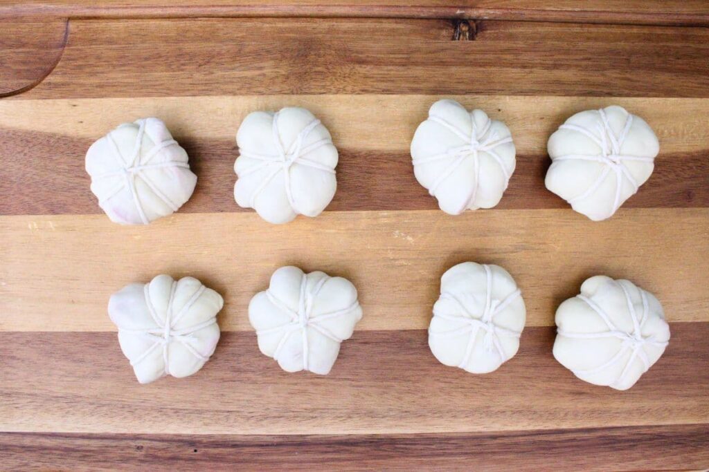 wrap a piece of twine around the dough four times forming eight divisions