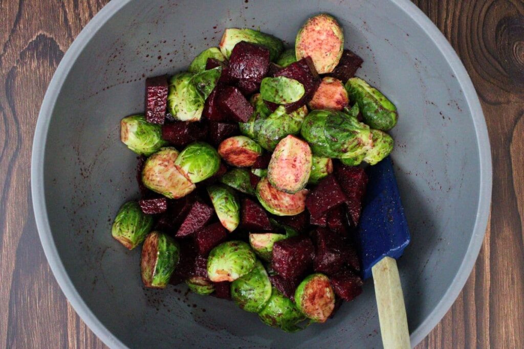 mix beets and brussels sprouts with your seasoning in a mixing bowl