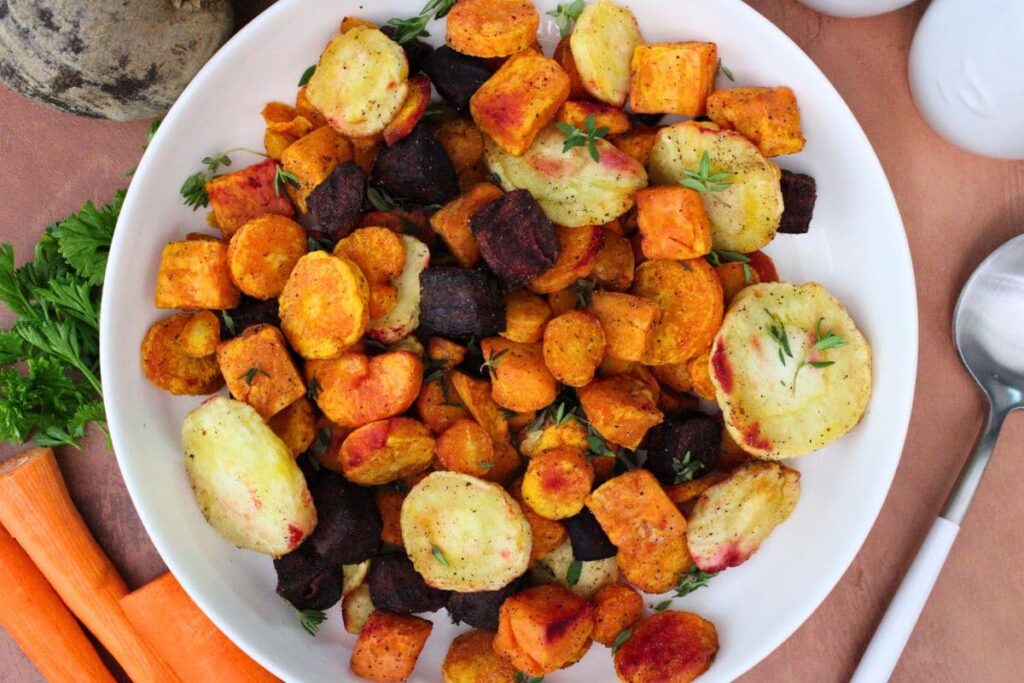 overhead view of air fryer root vegetables featuring beets, carrots, sweet potatoes, and parsnips